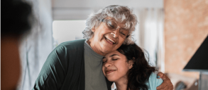A grandma and her granddaughter happy hugging each other - connected.