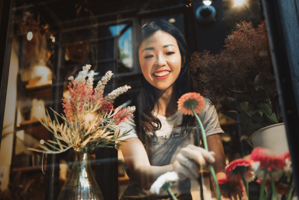 A smiling florist, working in her shop.