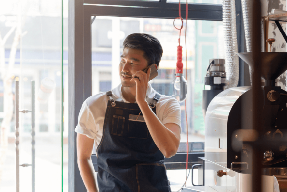 Person working in barista talking on the phone