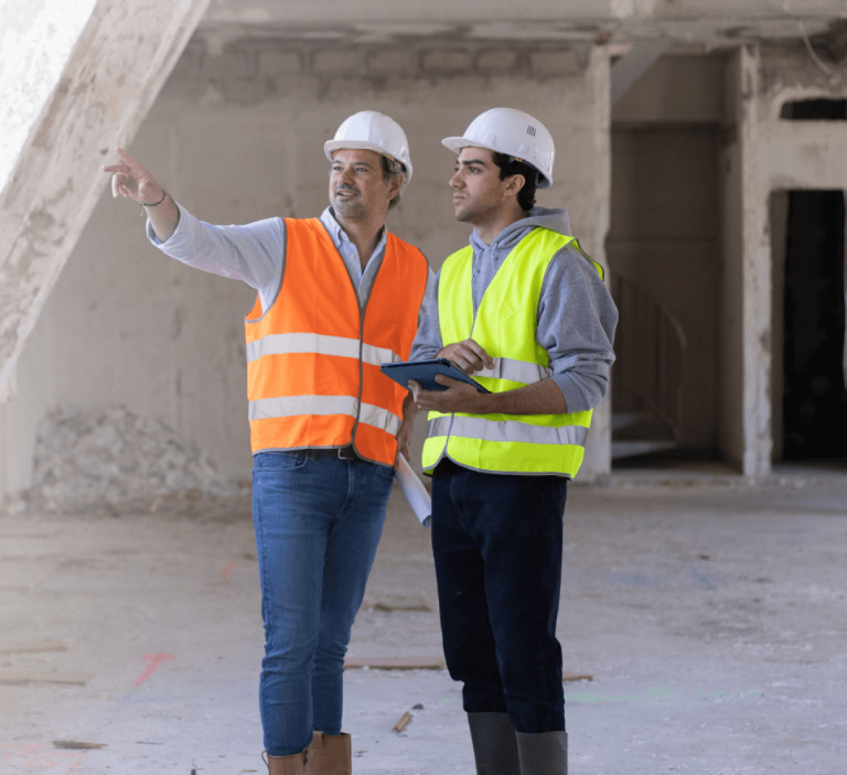 Construction workers holding a digital tablet at their work site